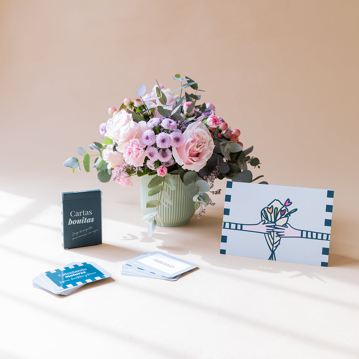 Arranjo de rosas com cartas de jogar e cartão