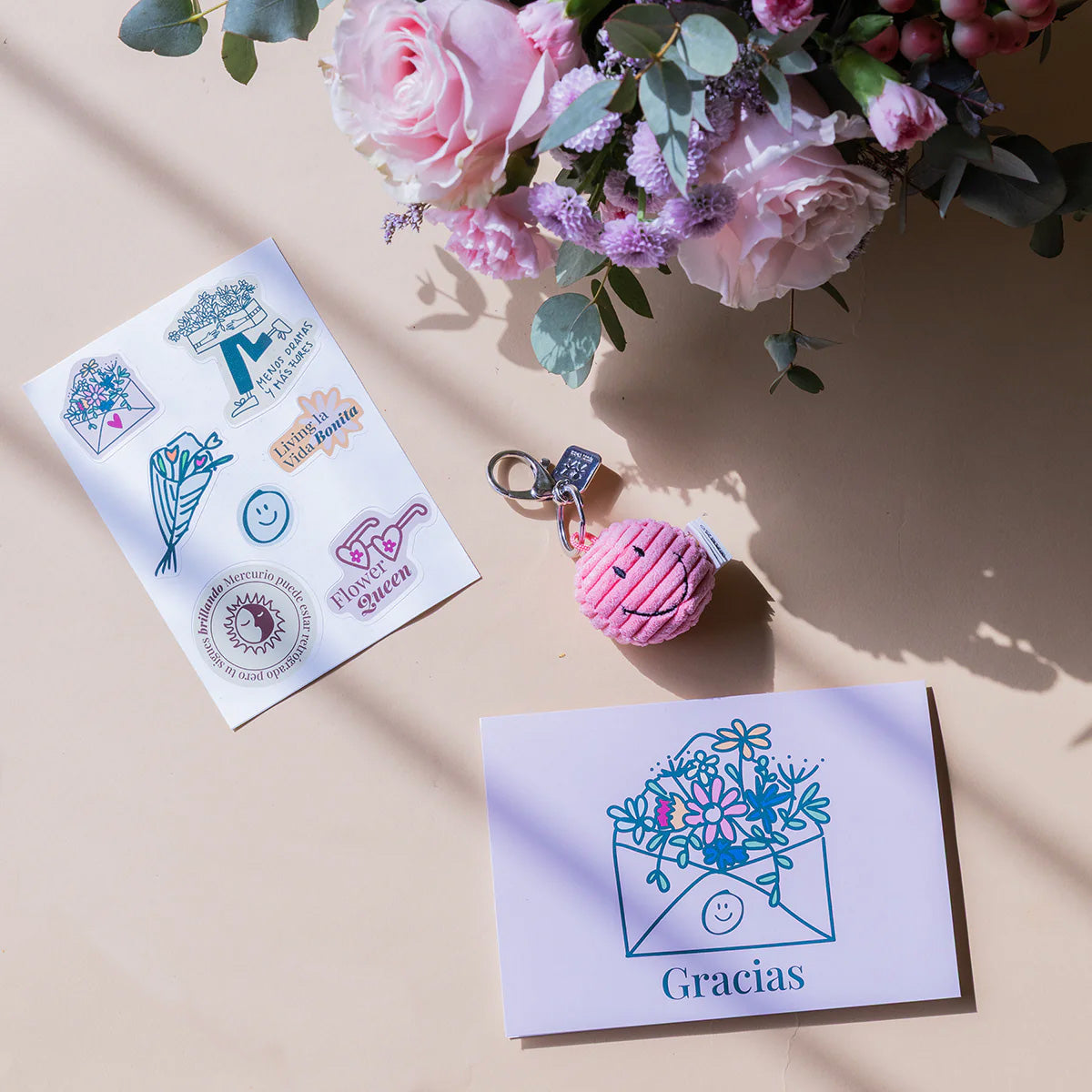 Arranjo de flores com porta-chaves, autocolantes e cartão.