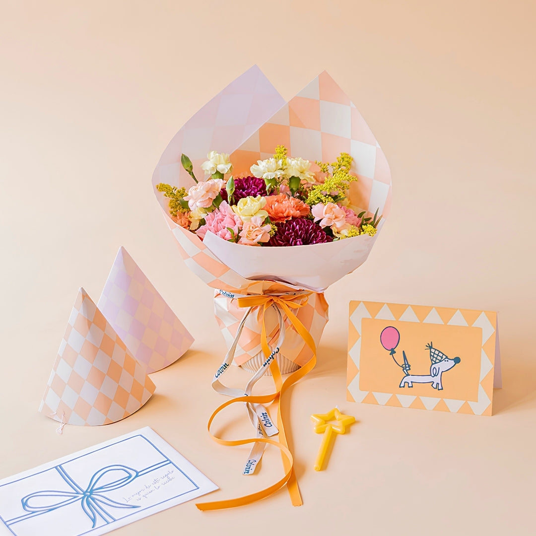 Arreglo de flores con envoltorio, gorros de fiesta, vela y tarjeta por 41,99 €