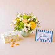 Pack de regalo de verano El Chiringuito con arreglo floral con base verde claro, caja de galletas Loison y tarjeta dedicatoria.