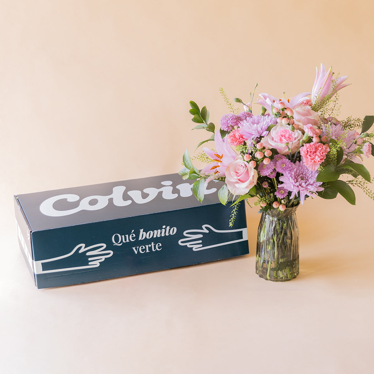 Caja de envío Colvin junto a ramo El Bonito de flores rosas en jarrón de cristal